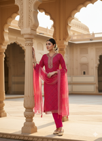 Load image into Gallery viewer, Woman in a pink traditional outfit standing in an ornate architectural setting
